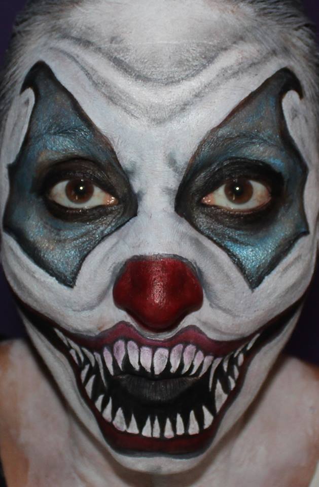 A close up of a person with a clown makeup