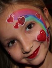 A girl with hearts painted on her face.