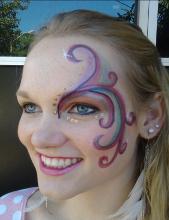 A woman with a face paint on her forehead.
