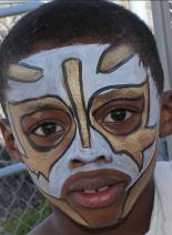A young boy with face paint on his face.
