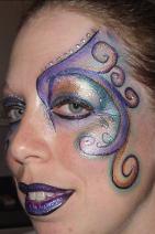 A woman with purple and blue makeup on her face.