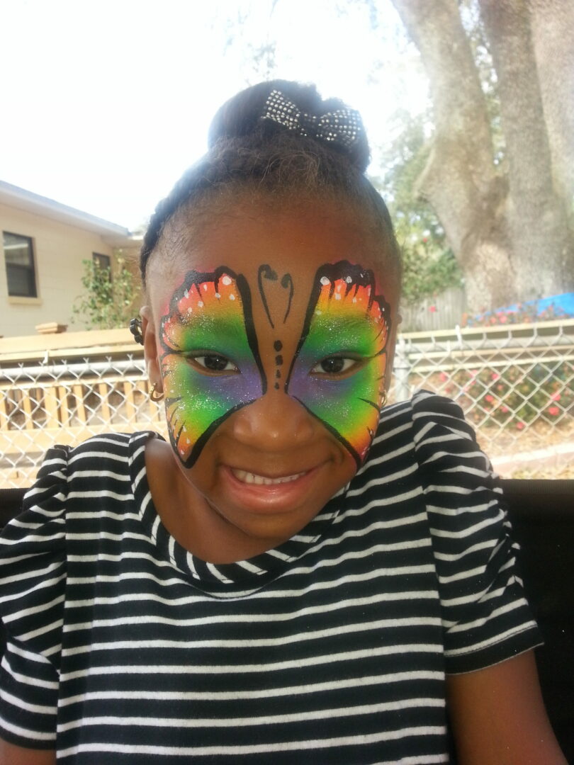 A woman with a face paint butterfly on her face.