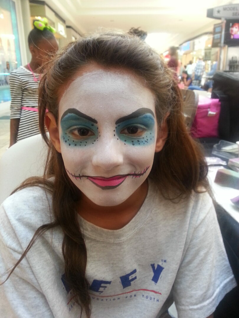 A girl with blue makeup on her face.
