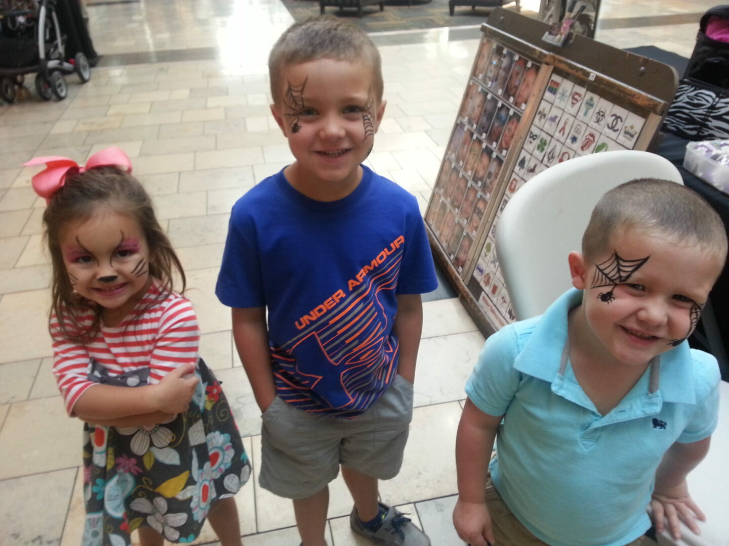 Two Young Boys With Spider Web Face Paint and a Young Girl