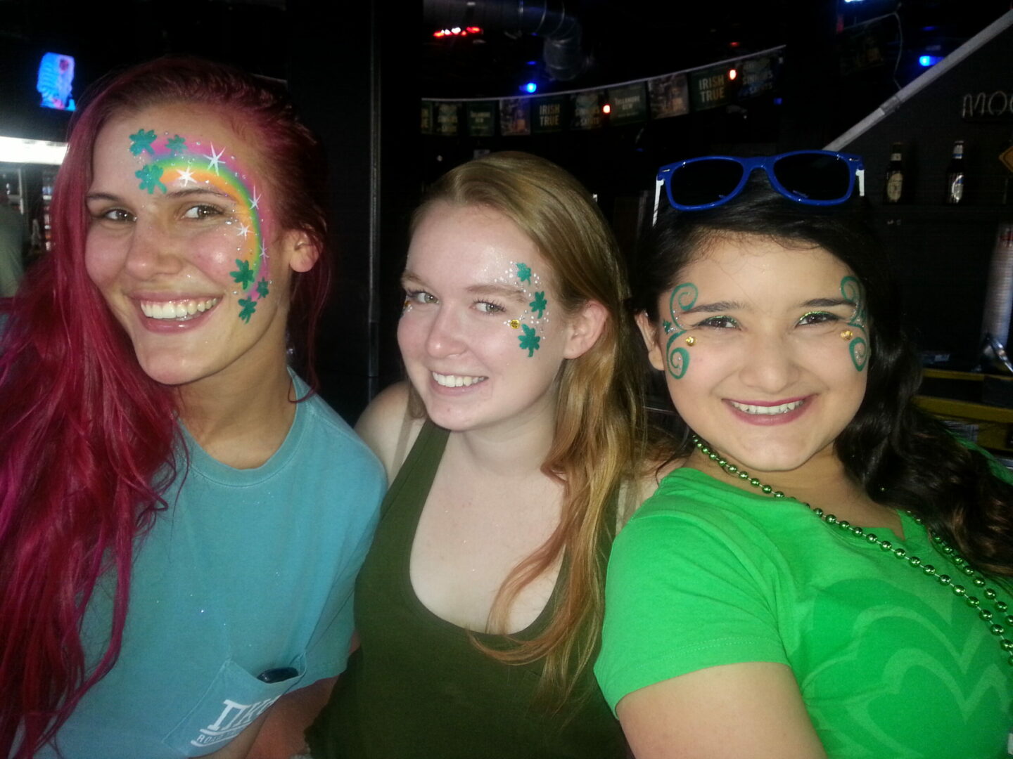 Three girls with face paint on their faces.