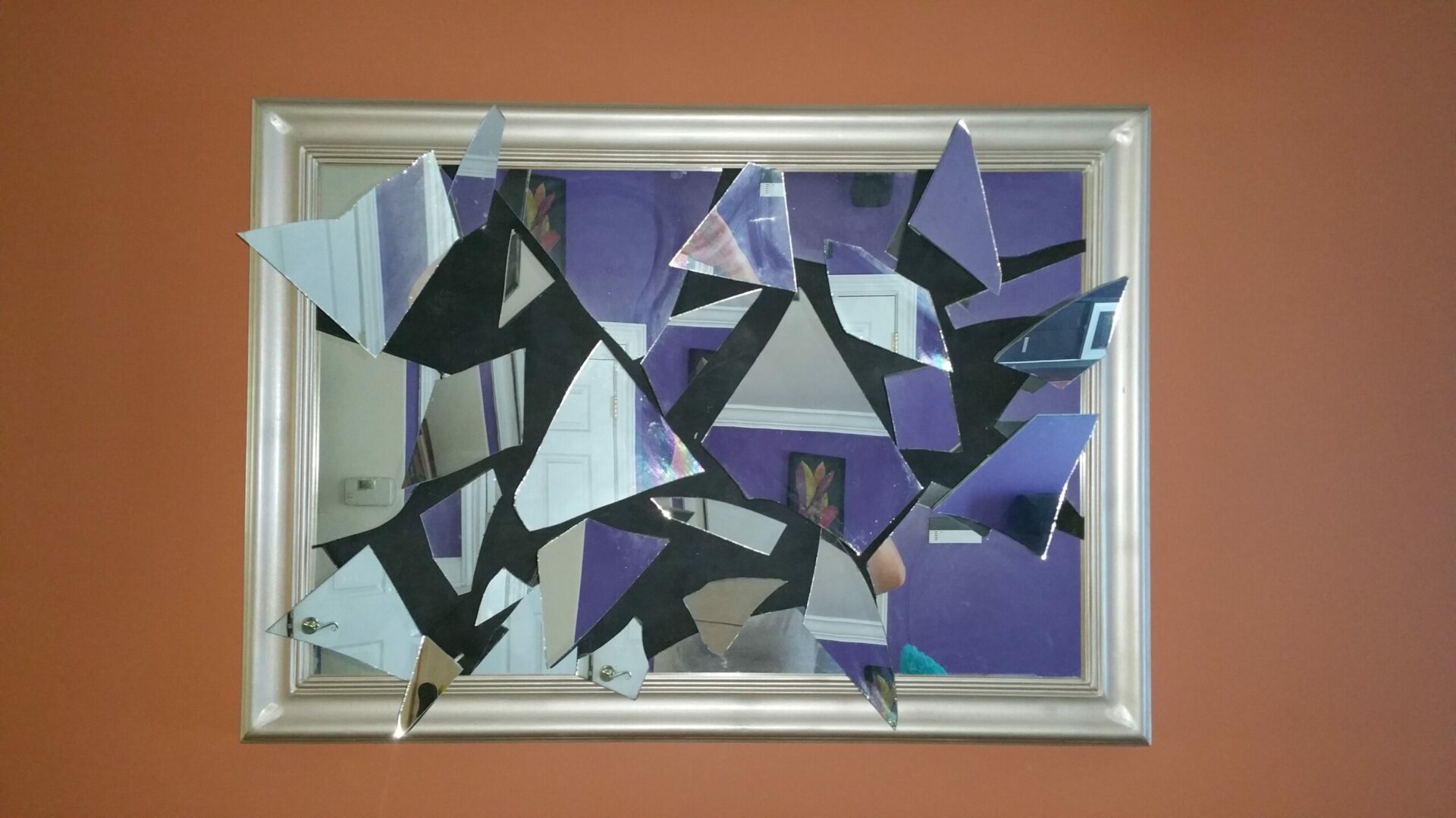 A mirror with purple and black triangles on it