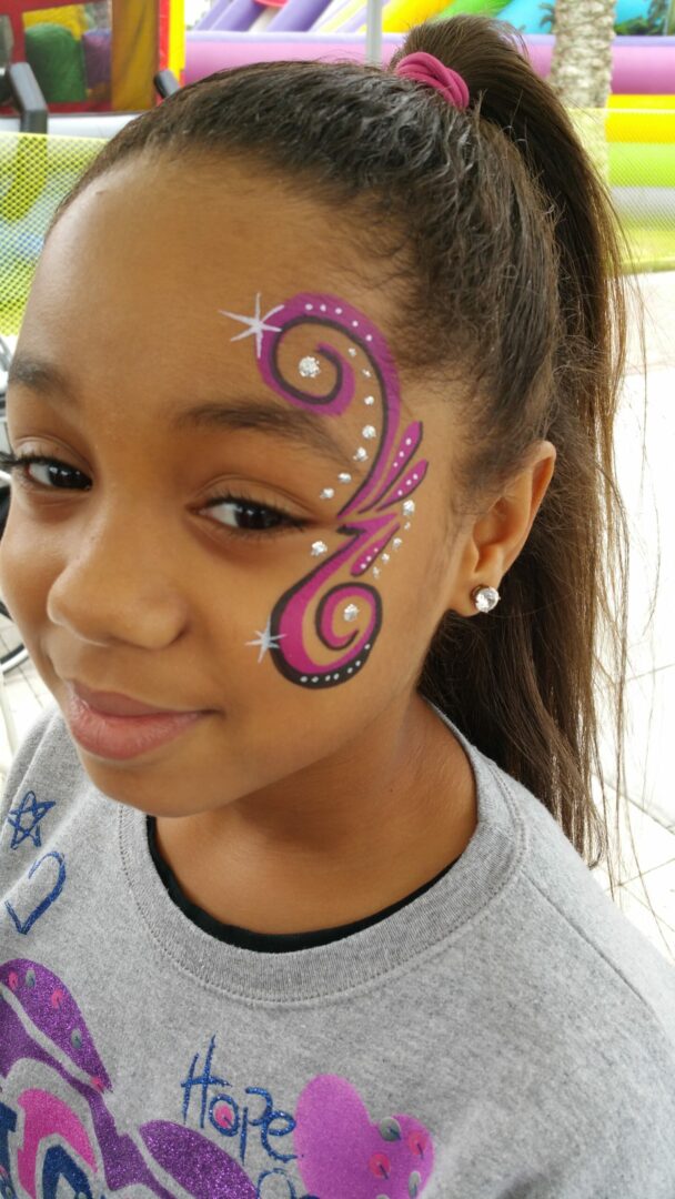 A girl with a face paint on her cheek.