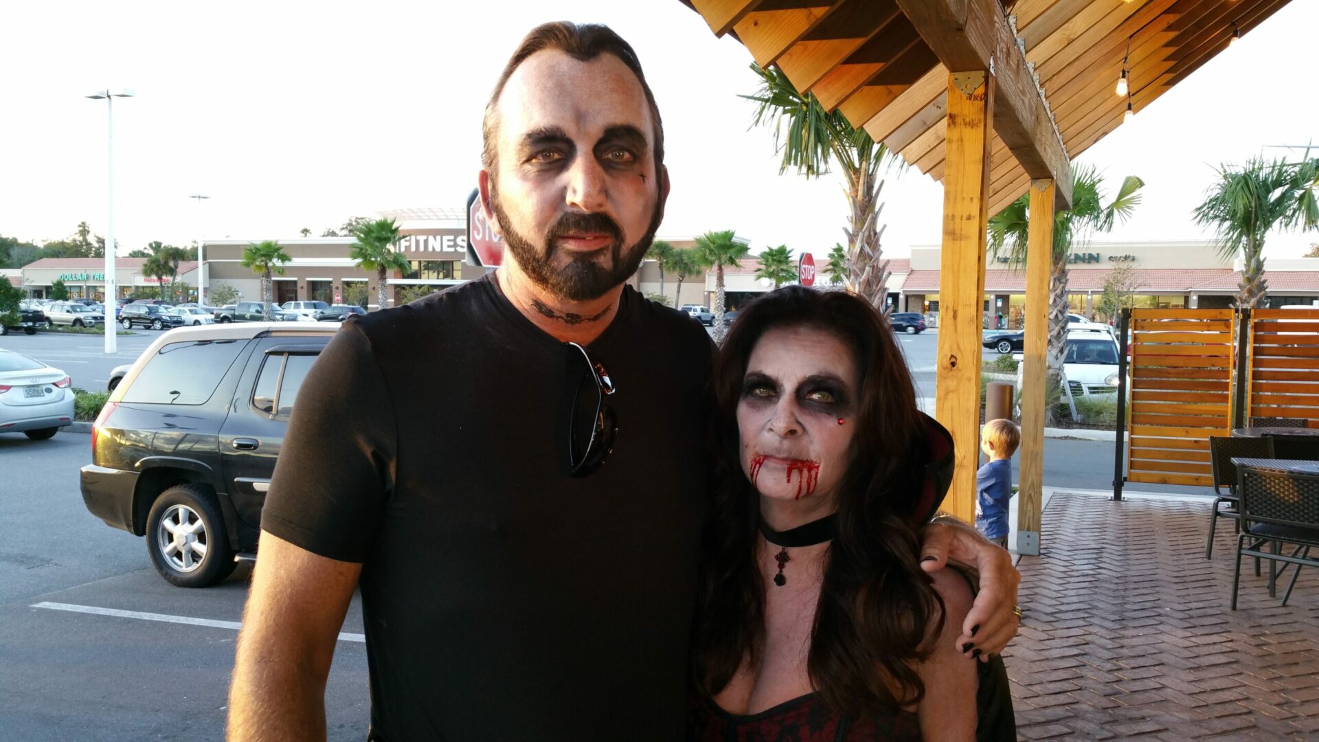 A man and woman dressed up as zombies.