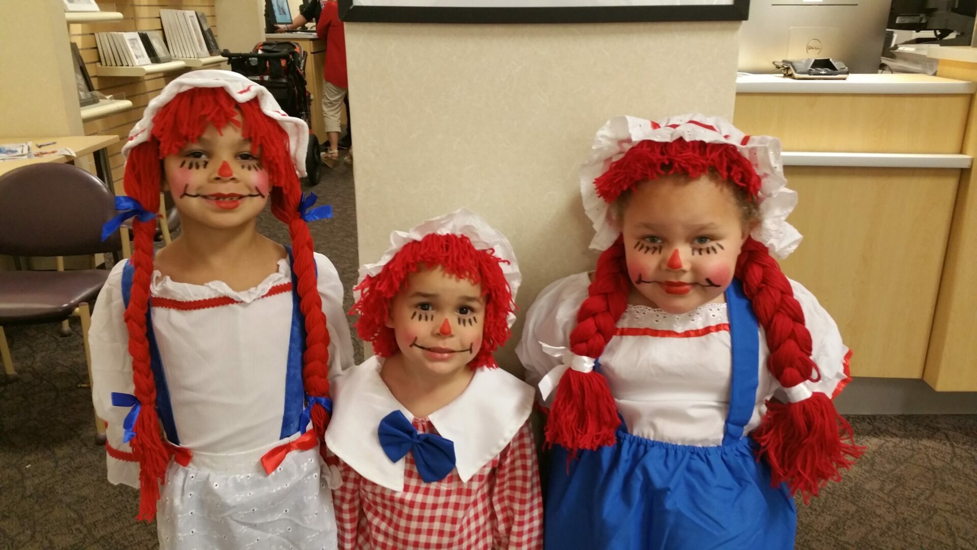 Three children dressed up as raggedy ann and andy