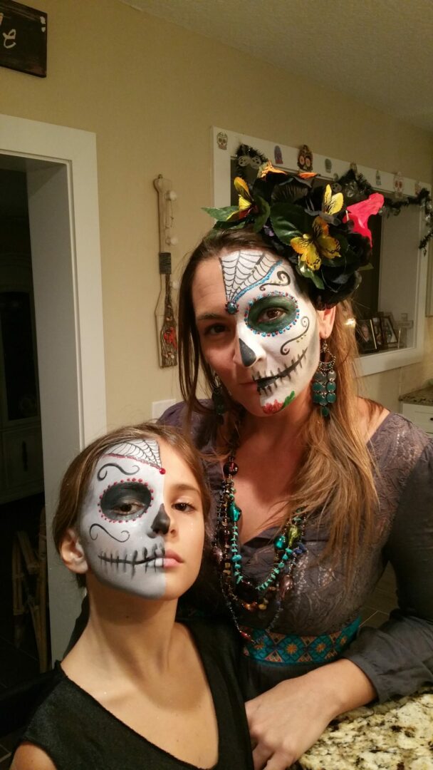 A woman and child with face paint on them.