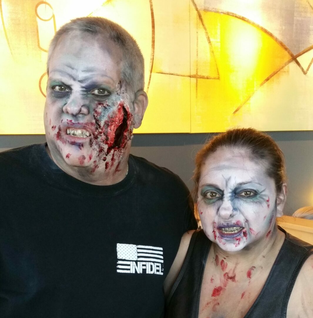 A man and woman dressed as zombies for halloween.