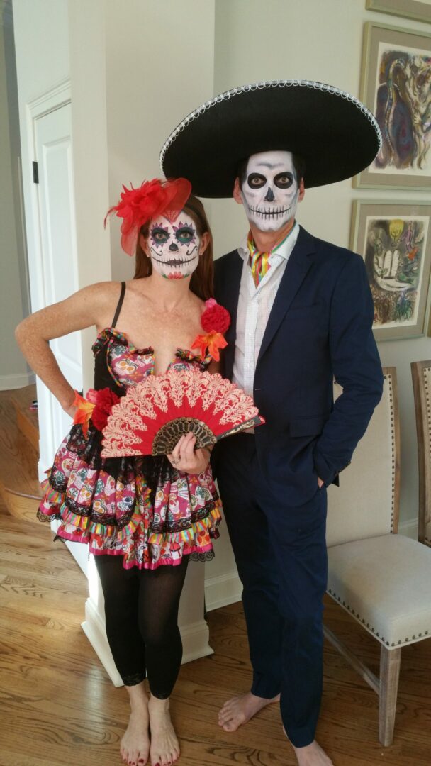 A man and woman dressed up as catrina for halloween.