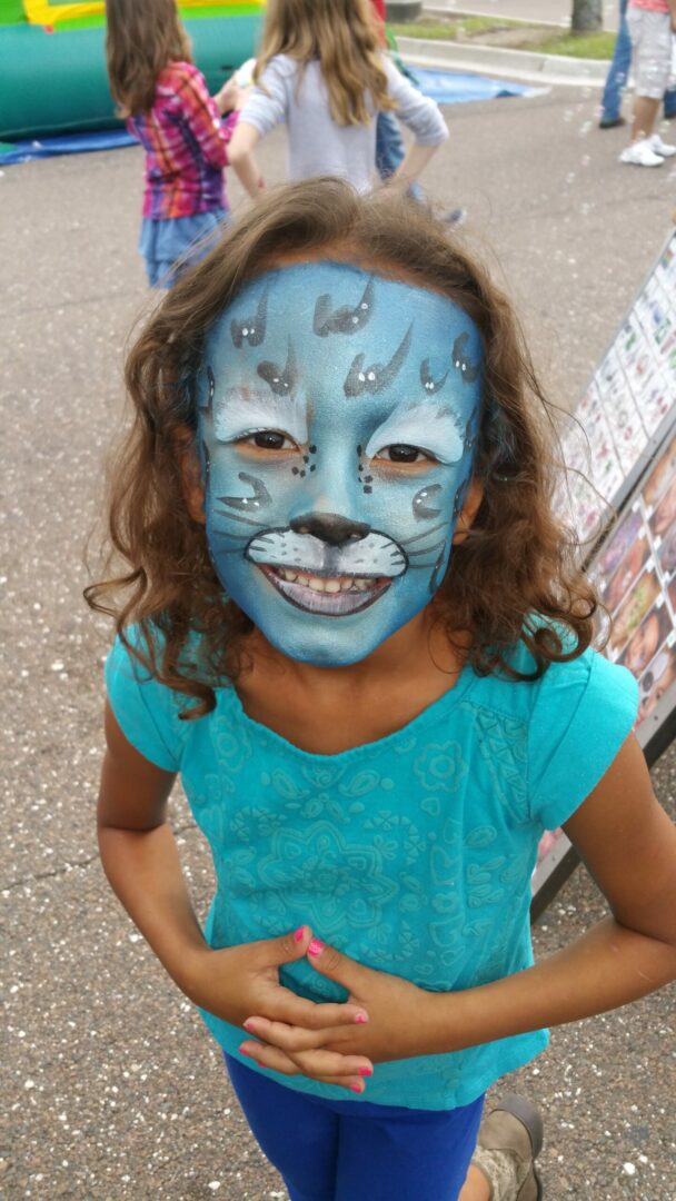 A little girl with blue face paint