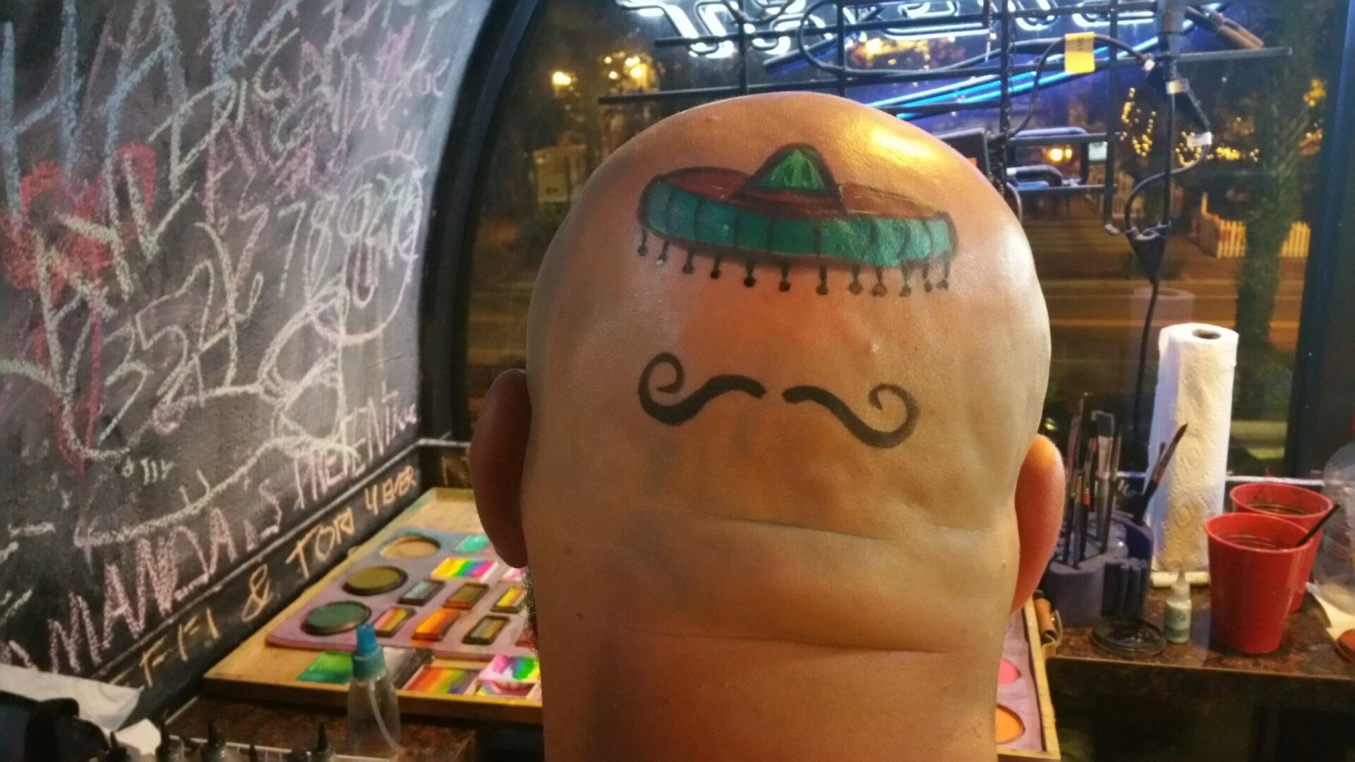A person with a mustache and a hat on their head.