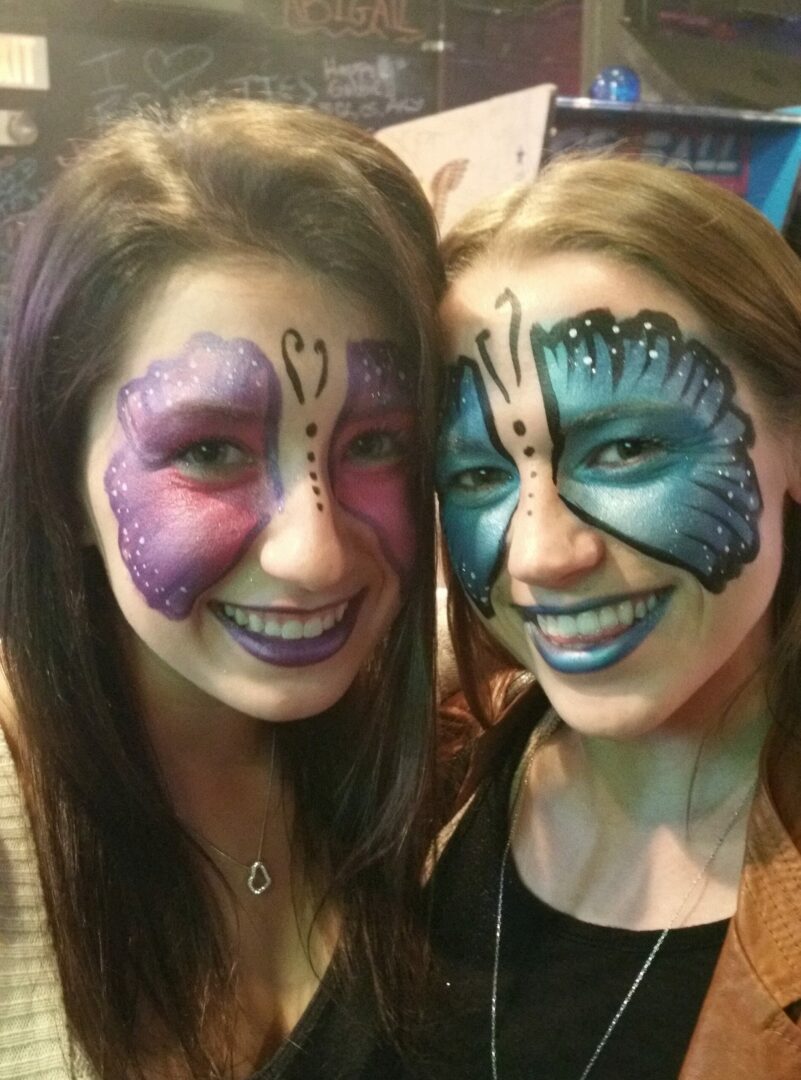 Two girls with face paint on their faces.