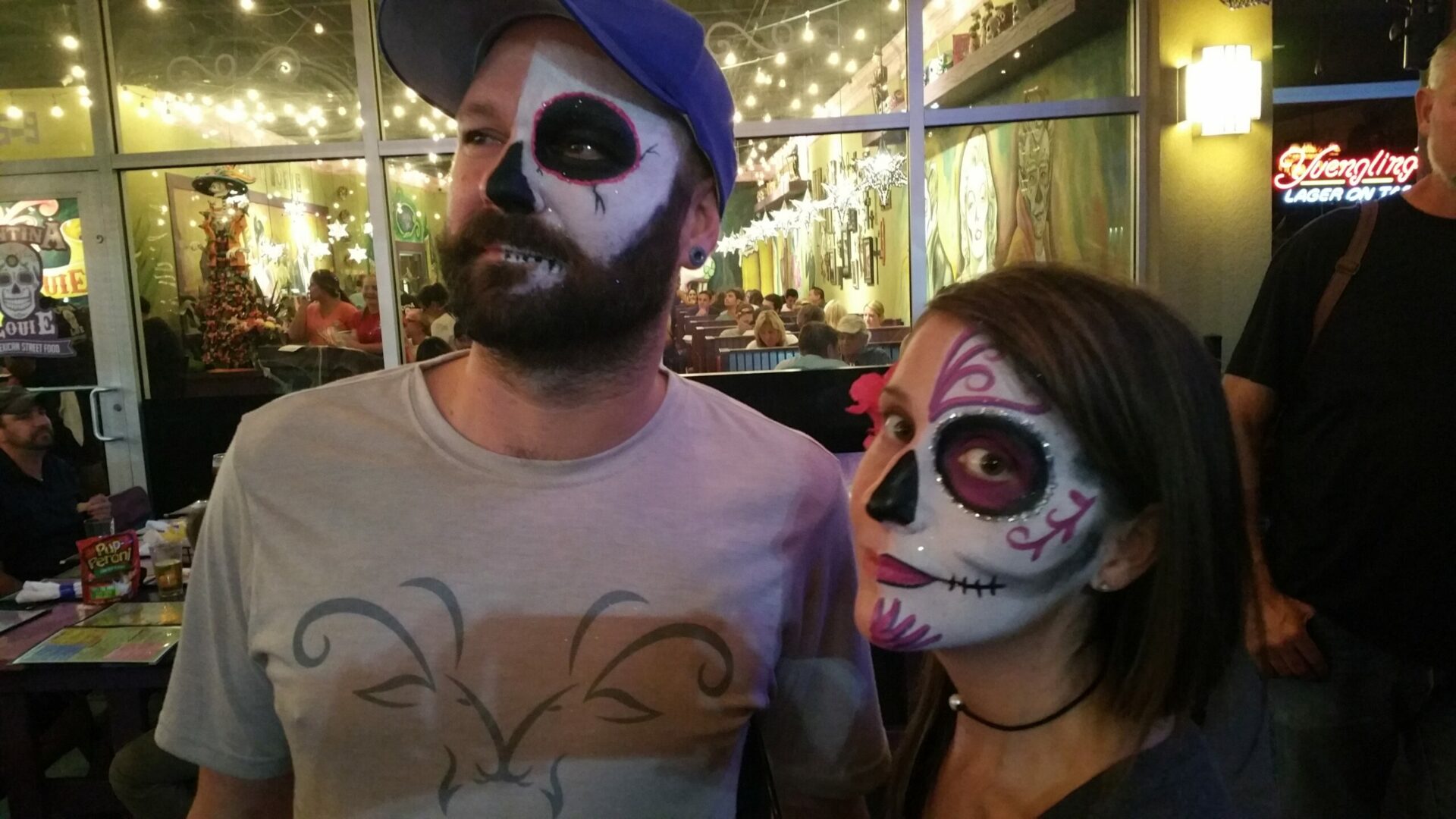 A man and woman with face paint on their faces.