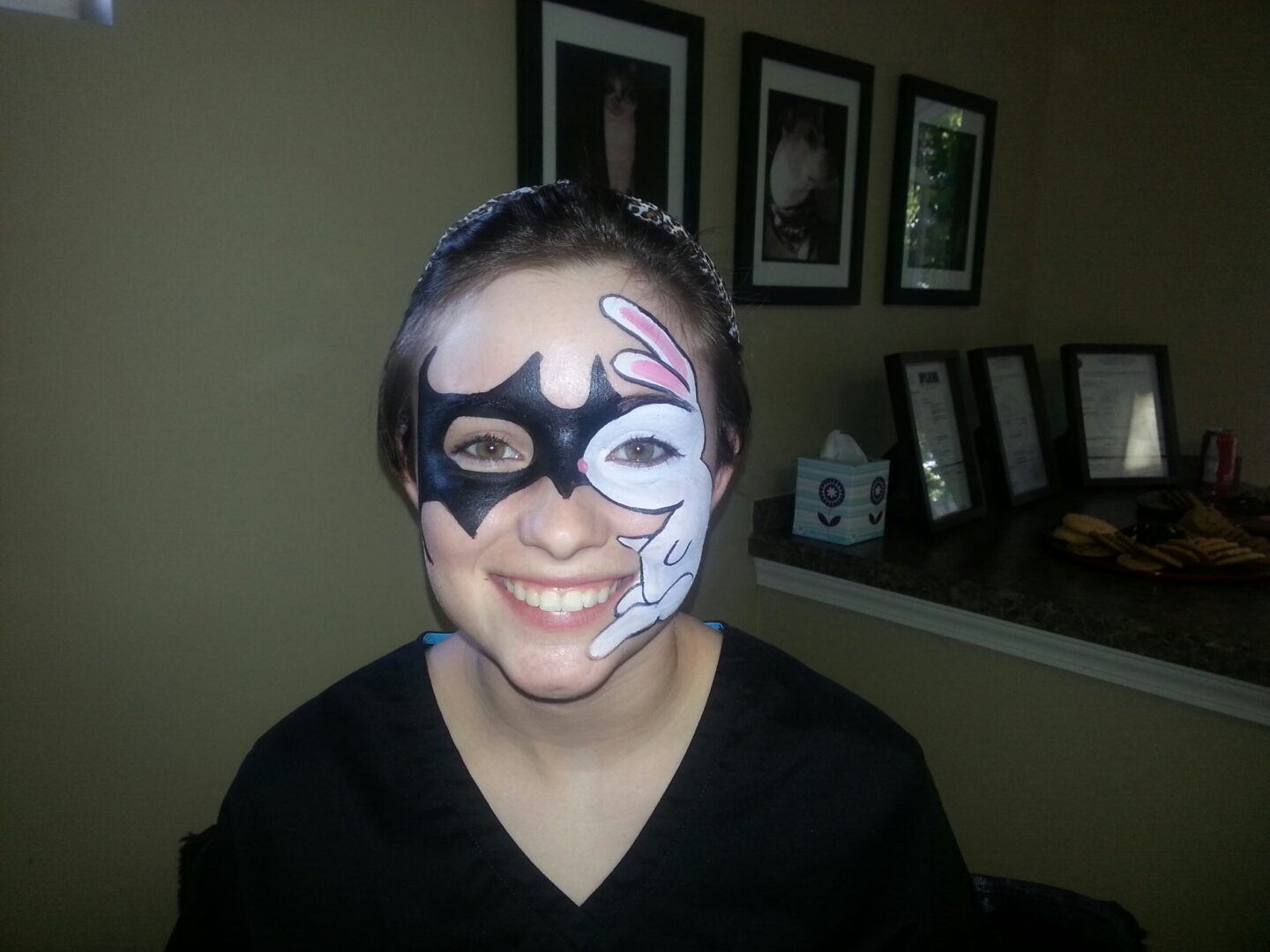 A woman with a face paint bat mask