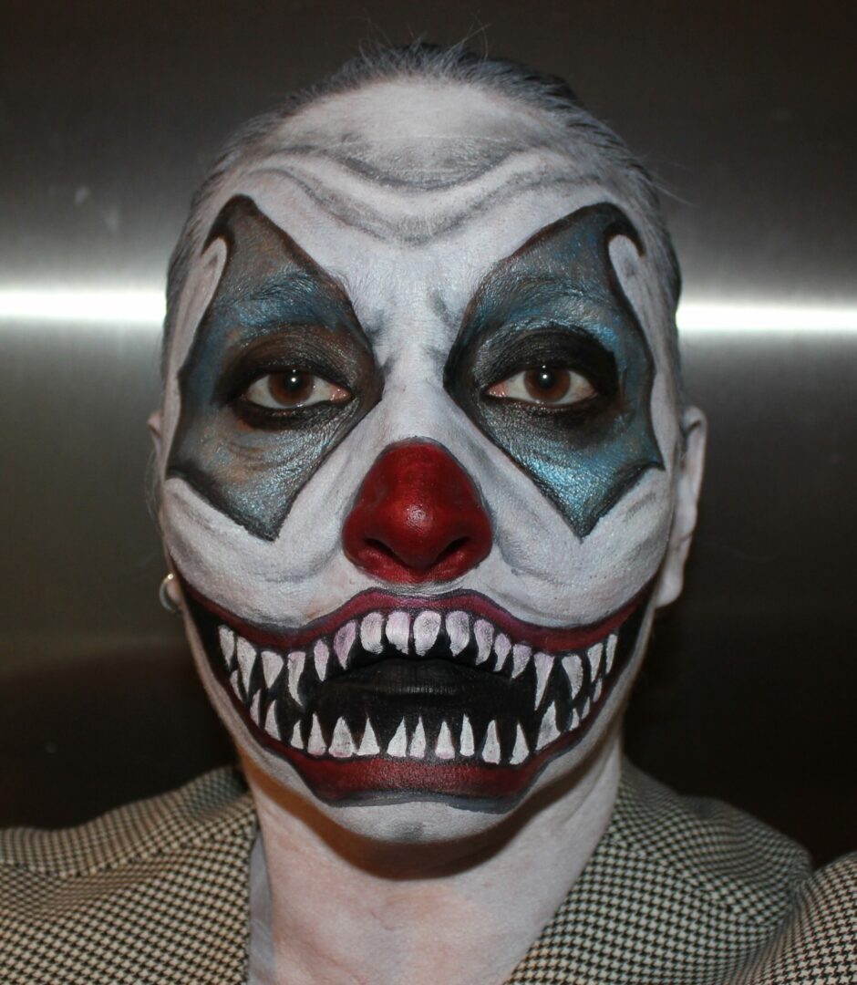 A man with a clown makeup on his face.