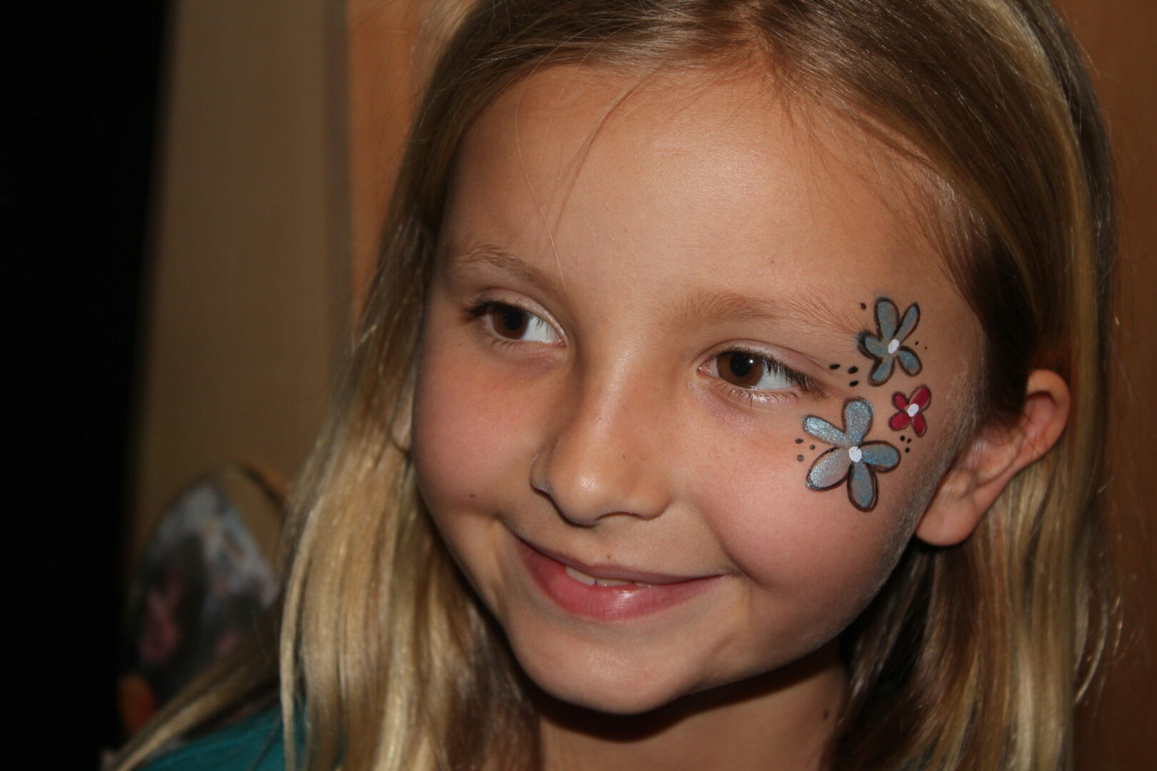A girl with flowers painted on her face.