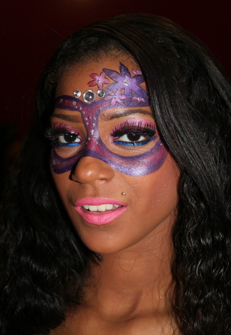 A woman with purple makeup on her face.