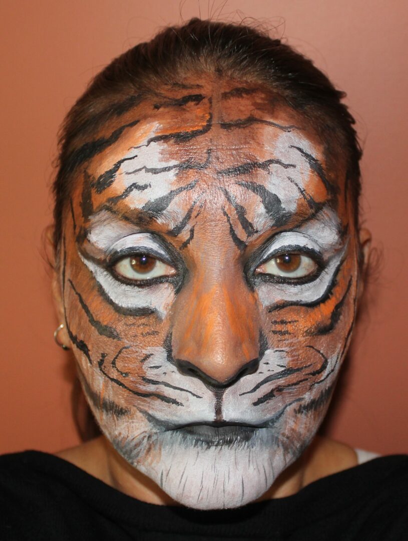 A woman with tiger makeup on her face.