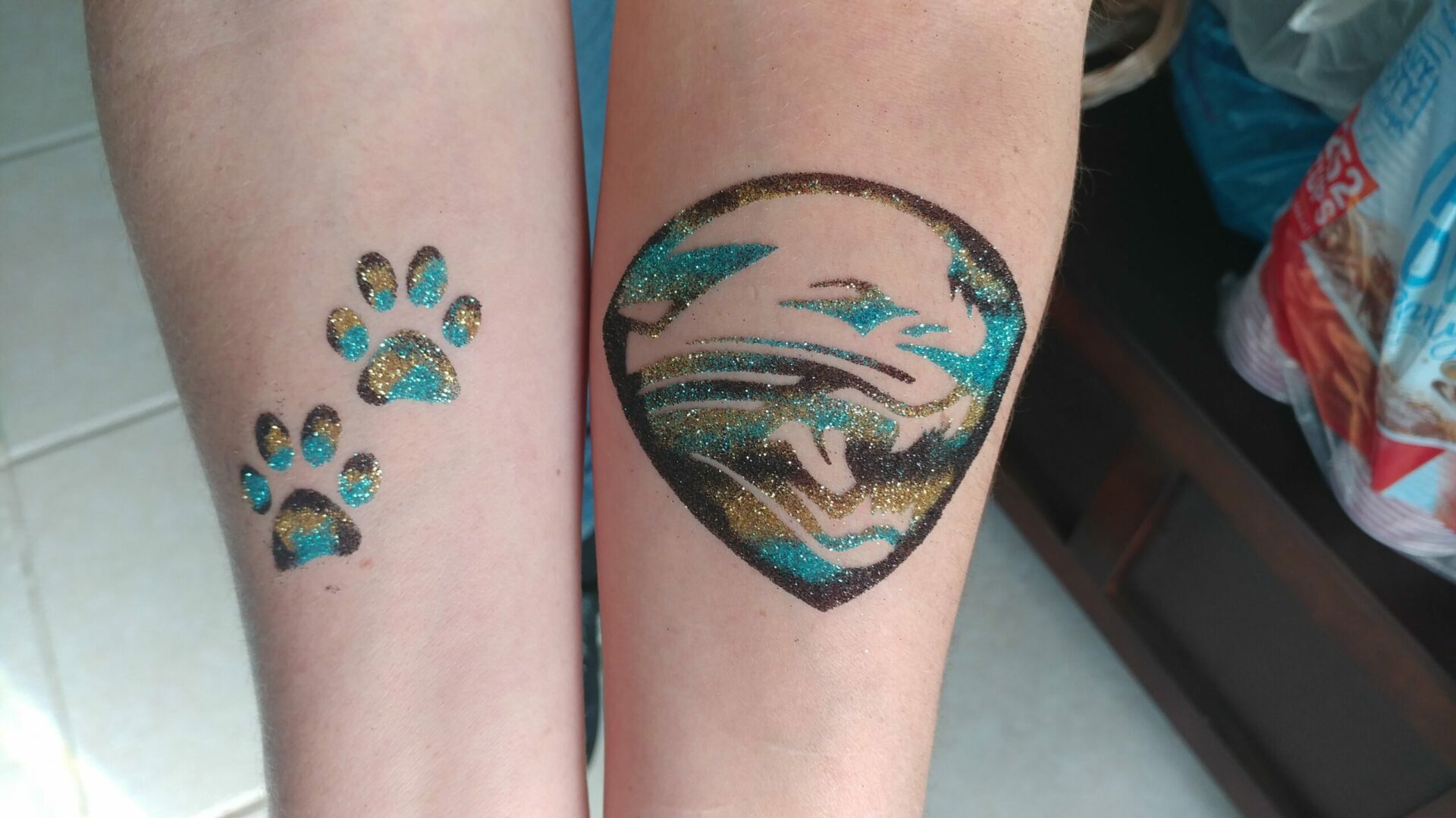 A tattoo of a dog 's head and paw print.
